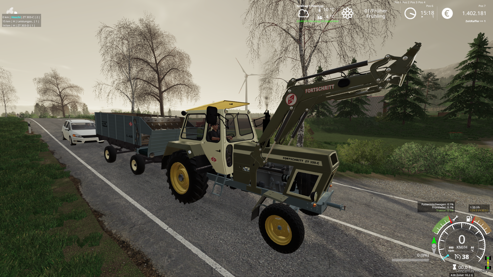 Mit dem Futterverteilwagen ab zu den Kühen.